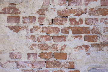 Bricks popping out through plaster