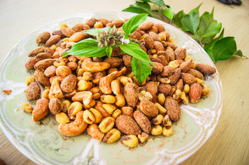 Salted fresh corn, almond cashew on plate with herbs and mint, A