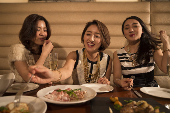 Women laughing while dining in the restaurant