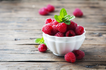 Sweet fresh raspberry and mint on the wooden table