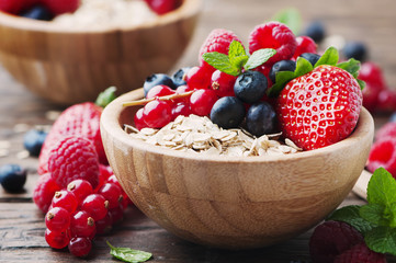 Oats withmix of berry on the wooden table