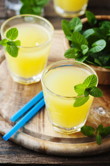 Yellow fresh cocktail with mint and ice