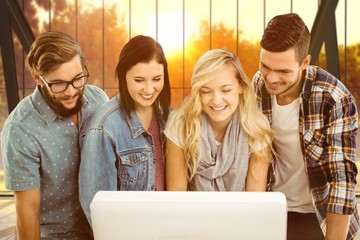 Composite image of smiling business people working at computer