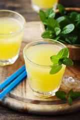 Yellow fresh cocktail with mint and ice