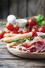 Antipasto with ham and green asparagus