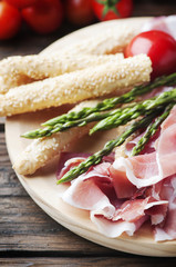 Antipasto with ham and green asparagus