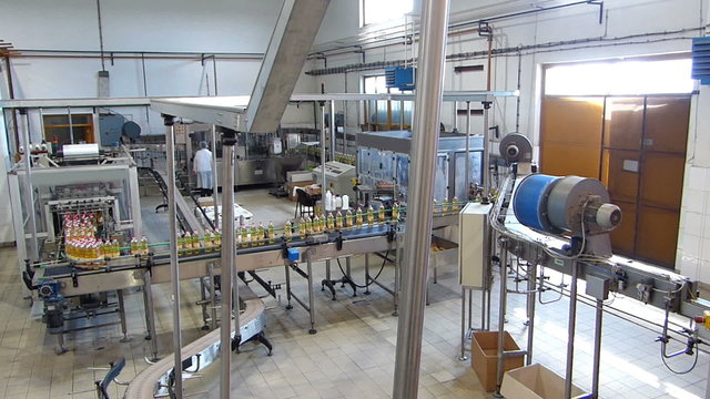 Sunflower oil in the bottle moving on production line in a factory
