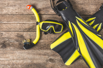 Snorkelling equipment on wood background - Powered by Adobe