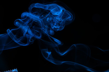 Blue smoke on black background