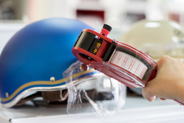 Hand holding shop pricing gun