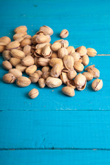 salted pistachios on a blue wooden table