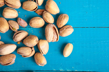 salted pistachios on a blue wooden table