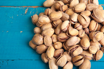 salted pistachios on a blue wooden table