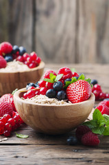 Oats withmix of berry on the wooden table