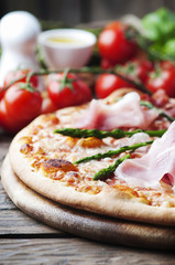 Italian pizza with ham and asparagus