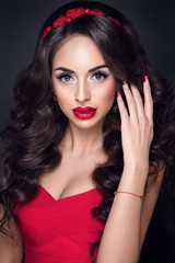 Beautiful woman portrait with excellent makeup and nice hairstyle. Red lipstick and red accessories  