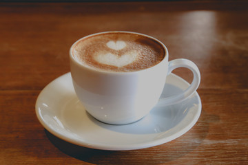 Best latte coffee in life on brown wood table.