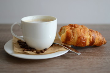 cup of coffee and yummy croissant