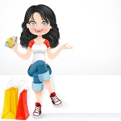 Beautiful brunette girl with a credit cards in his hand sitting