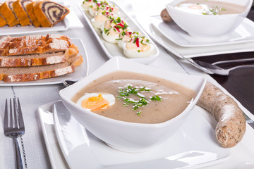 Easter traditional breakfast with white borsch soup, eggs and sausages