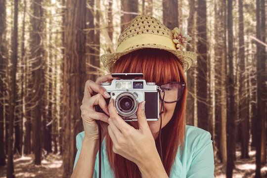 Portrait Of A Smiling Hipster Woman Holding Retro Camera