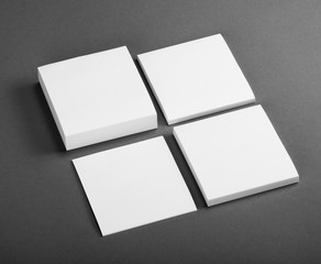 Collection of white note papers on gray background.