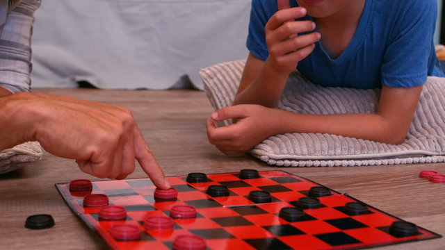 Father and son playing board game