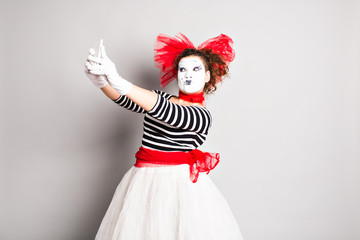 Mime taking a selfie photo. Woman with smartphone. Concept of  April Fools Day.