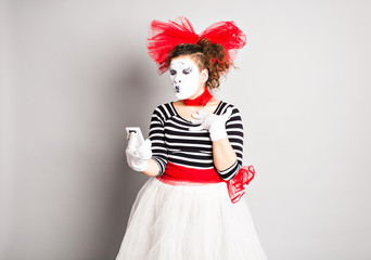 mime with smartphone. Concept of  April Fools Day.