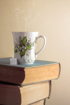 Cup of tea on stack of old books