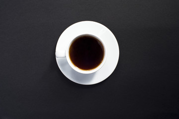Cup of coffee on black background.