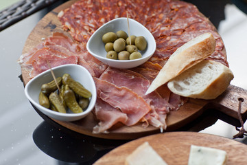 Wine appetizers set: meat and cheese selection, grapes and bread