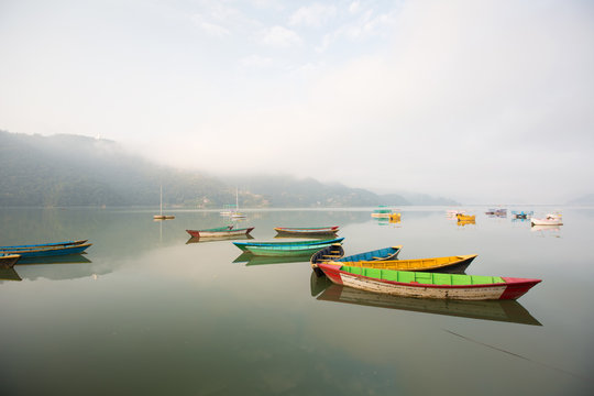 Colorful Boats on Mountain Lake Landscape. Abstract fishing, nobody