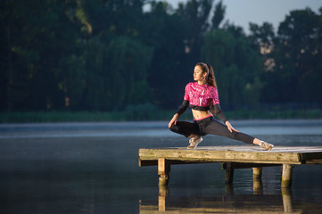 woman streching before her workout on the river
