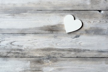 Old wooden floor with a white wooden heart