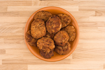 Fried cutlet in the plate on wooden table