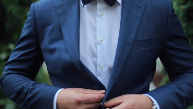 Buttoning a Jacket. Stylish Man in a Suit Fastening Buttons on His Jacket Preparing to Go Out Close up