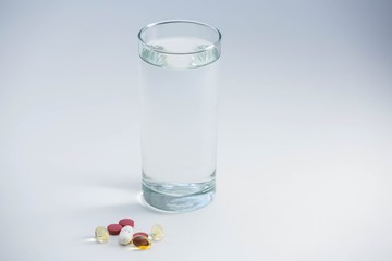 Pills beside glass of water