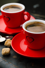 Red cup of coffee and coffee beans