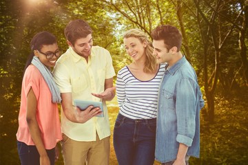Naklejka premium Composite image of happy creative team using a tablet pc