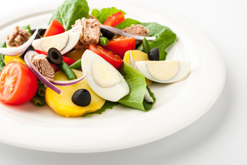 Nicoise salad on the white ceramic plate