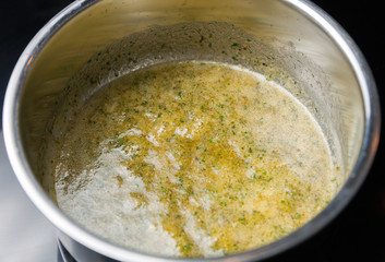 Preparing sauce with spices for vegetables in pan