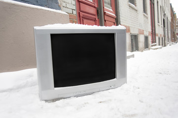 old TV left on the street winter