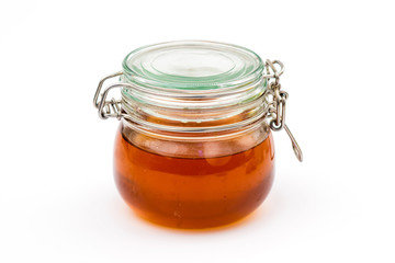 Honey jar on white background