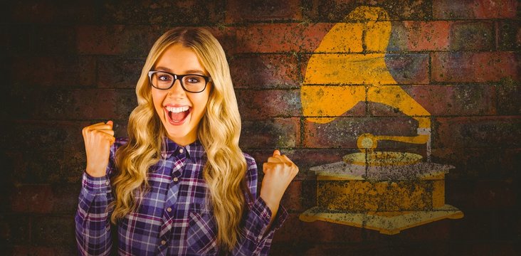 Composite image of gorgeous blonde hipster celebrating success