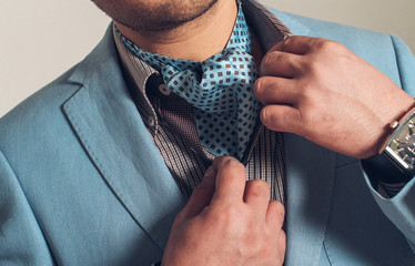 A man in a suit with a blue tie