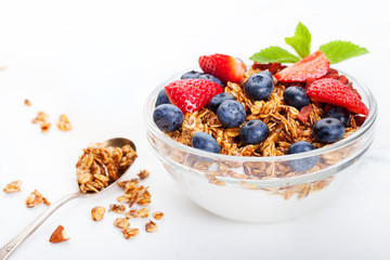 Healthy breakfast Fresh granola, muesli in bowl with milk and berries White background