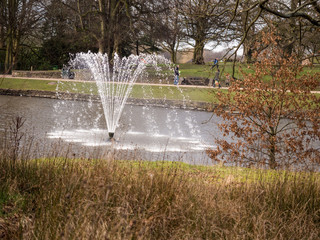 Strong winds blowing water fountain at Astley Park, Chorley, Lancashire, UK