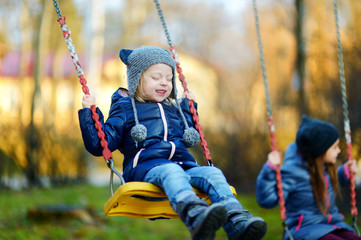 Cute little girl having fun on a swing