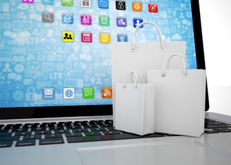 laptop and  shopping pags on white background